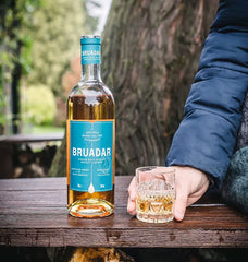 Bruadar Scotch Whisky Liqueur with glass in hand
