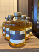 Hirundine 12 year old, Single Malt Whisky, 70cl bottles displayed on a wooden shelf.